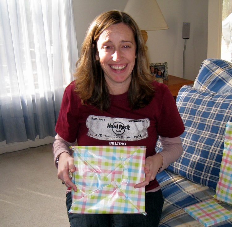 Before she opens, she feel the need to ridicule my gift wrapping skills!